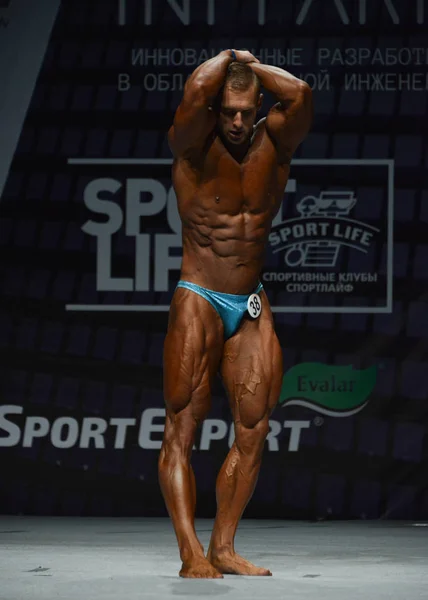 Bodybuilder shows his abdominal — Stock Photo, Image