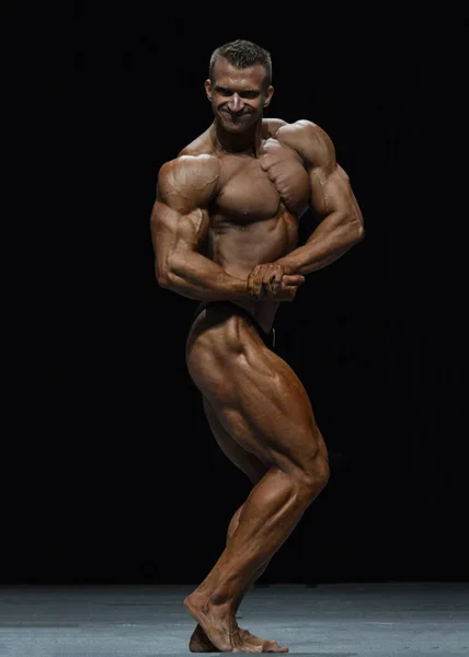 Bodybuilder ukazuje jeho fyzičtina — Stock fotografie