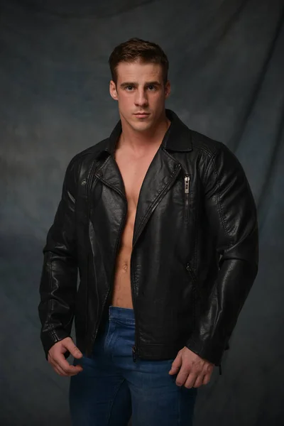 Fitness male model in leather jacket