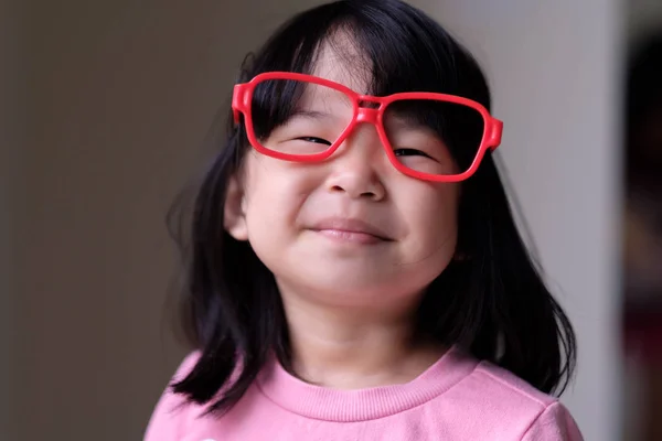 Funny little child with big red glasses — Stock Photo, Image