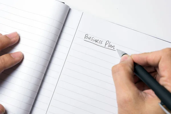 Close-up of male hand writing down business plan — Stock Photo, Image