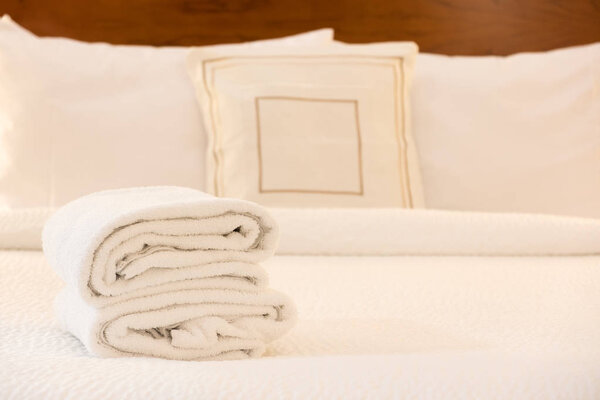 White towel on bed in hotel room
