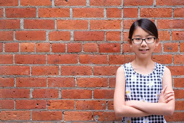 Portrait de jeune fille asiatique contre le mur de briques rouges — Photo