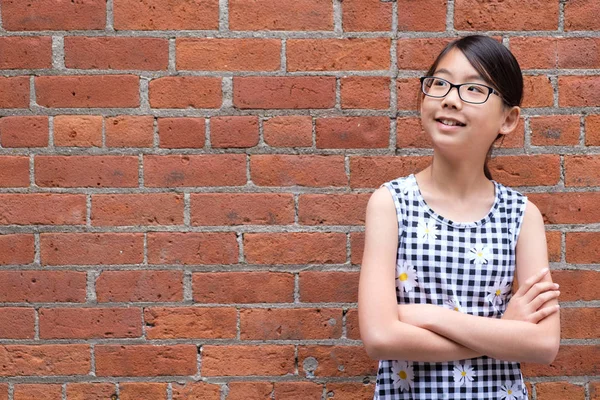 Portrait de jeune fille asiatique contre le mur de briques rouges — Photo