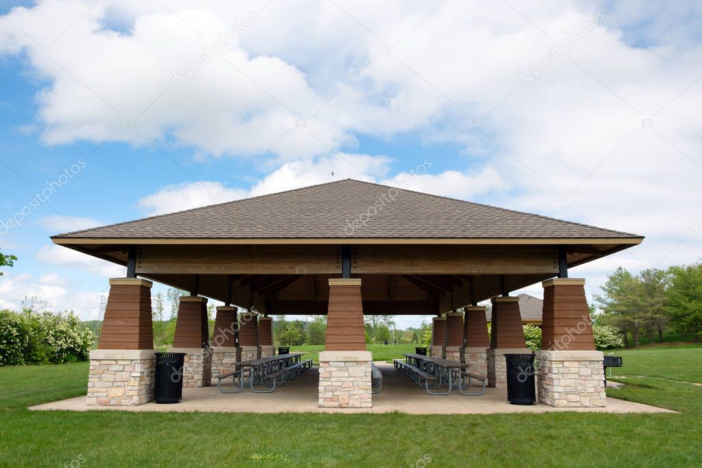 Covered picnic area and tables in public park.