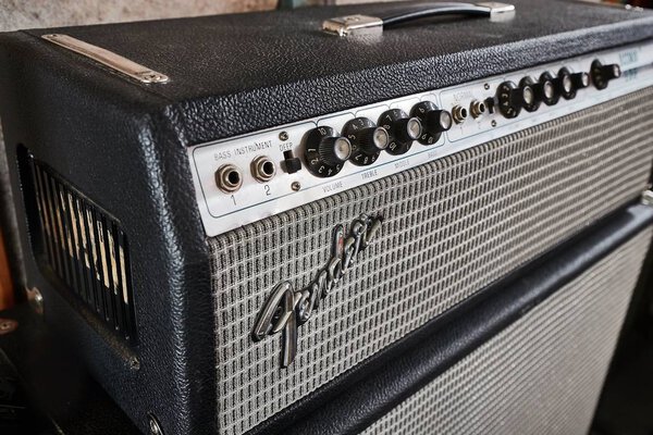 HOFN, ICELAND - MAY 4, 2018: Fender Bassman 135 vintage amplifier head on a big speaker cabinet