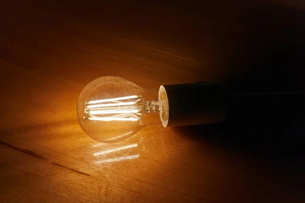 Light bulb on a table — Stock Photo, Image