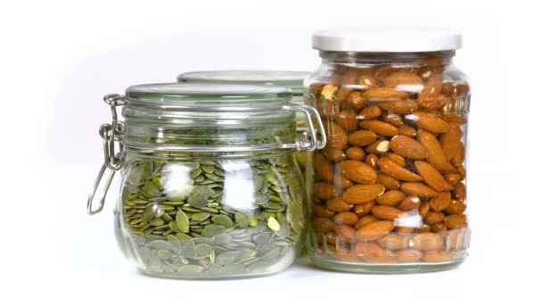 Mix of nuts and seeds in jars — Stock Video