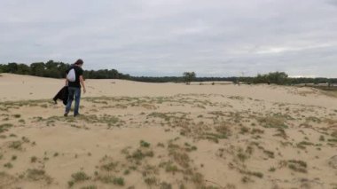 Man walking seeking solitude in the sand dunes