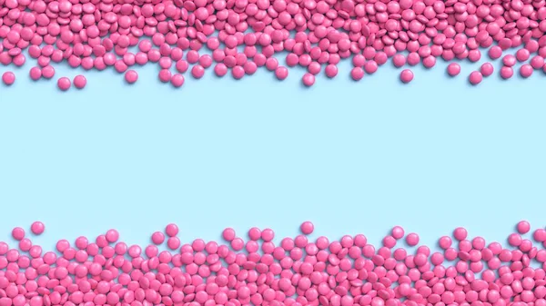 Doble borde de caramelos de chocolate recubiertos de rosa sobre fondo pastel azul — Foto de Stock