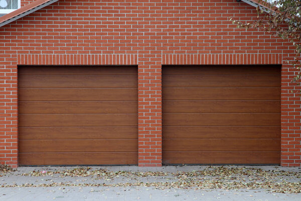 Brick garage for two cars with automatic gates.