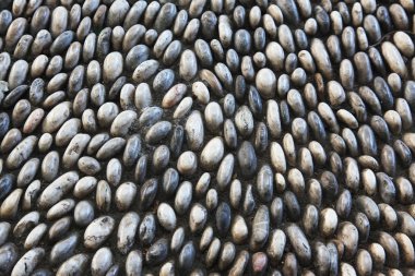 Doku ve arka plan küçük çakıl taşları ile. Rodos'ta bir sokakta kaldırım. Yunanistan