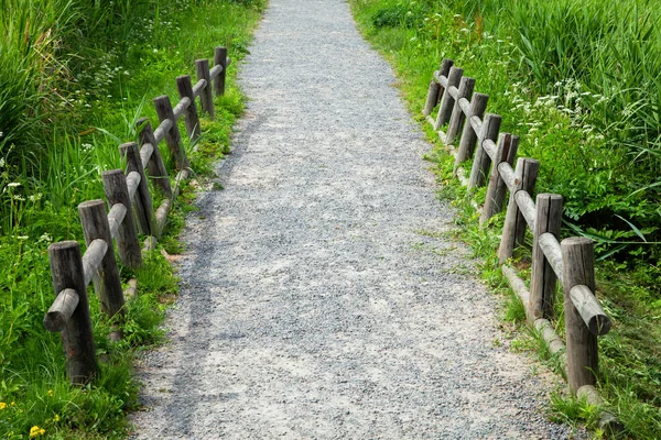 Walking path with a wooden fence. — Stock Photo, Image