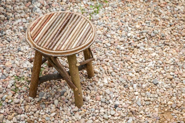 Simple rustic wooden chair. Retro stool on breakstone background — Stock Photo, Image