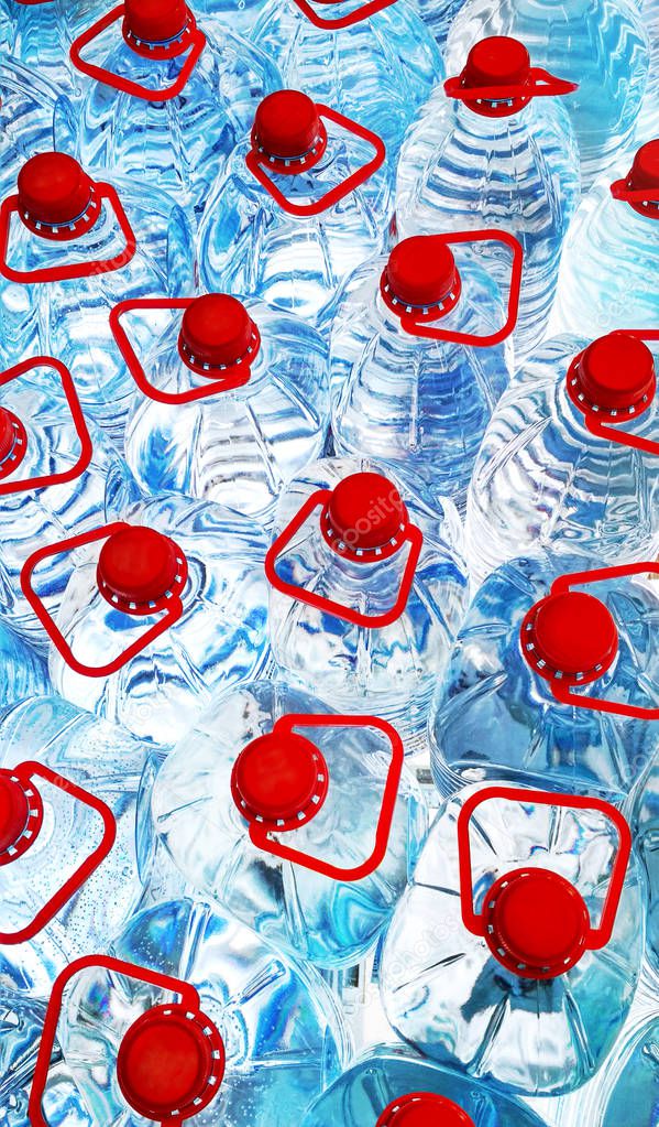 Rows of big plastic bottles with red covers, blue water 