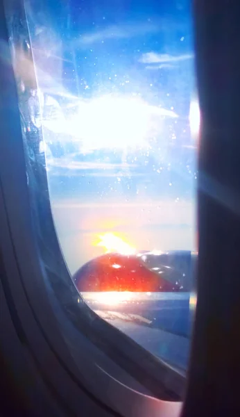 A view at Sunset from the airplane window, reflects