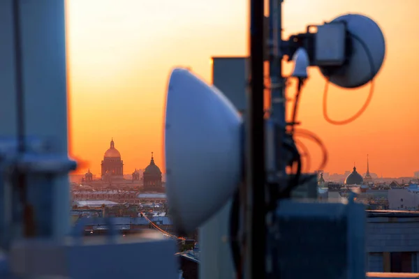 Cellular antennas, city, sunset, roofs, Saint-Petersburg, wide