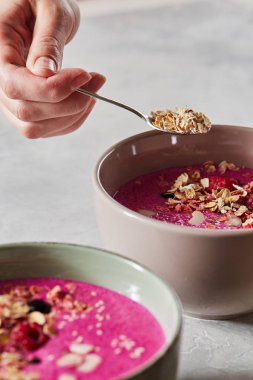 kadın beslenme yüzlü granola ve çilek, sağlıklı bir kahvaltı ile 