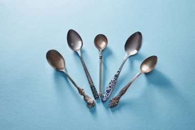 Metalik vintage kaşık üzerinde mavi arka plan sundu