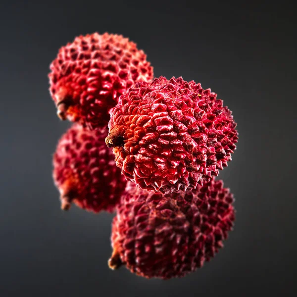 tropical pink Lychee fruits on dark background