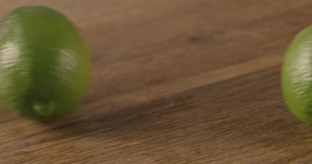 Two Fresh Green Limes Wooden Table — Stock Video