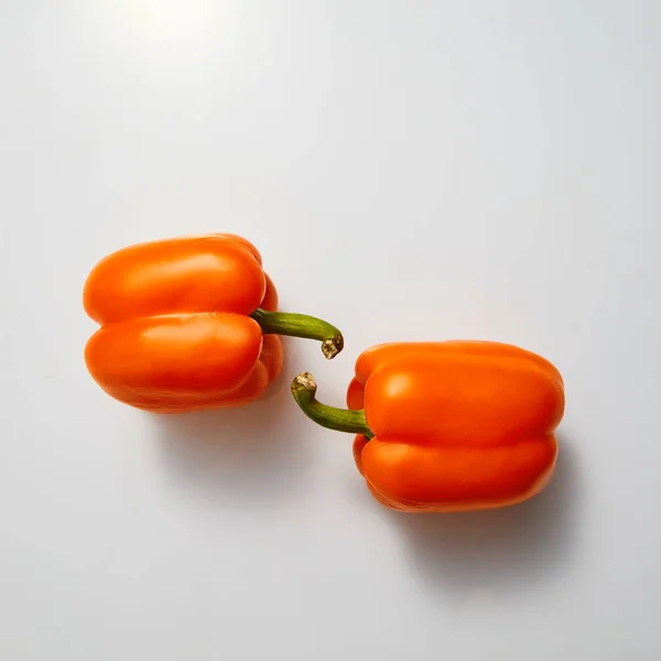 Two Whole Orange Paprika Peppers Blue Background Flat Lay — Stock Photo, Image
