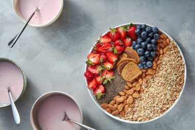 Olgun çilek, yaban mersini, granola ve badem, sağlıklı vitamin kahvaltı beton tablo ile ev yapımı yoğurt 
