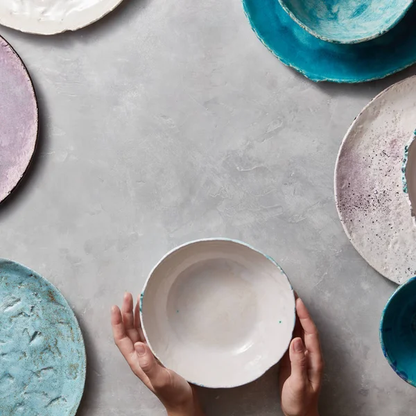 Colorful Porcelain Pottery Bowls Stone Gray Background Female Hands Holding — Stock Photo, Image