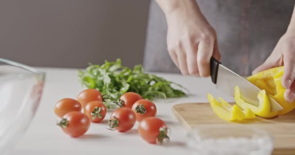 Female Hands Cutting Yellow Paprika Wooden Board — Stock Video