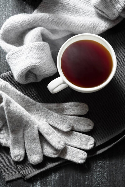 knitted clothes and cup of drink, autumn or winter concept 