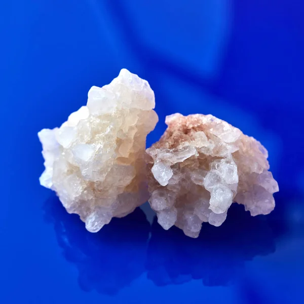 Big white salt crystals on violet background — Stock Image Big White Salt Crystals Violet Background Royalty Free Stock Images