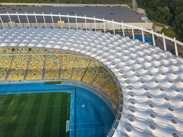 KIEV, UKRAINE - July 19, 2018. Birds eye view from drone of the stadium cover structure - National Sports Complex Olimpiysky at summer sunset. Abstract architecture photo. Construction of the stadium roof.