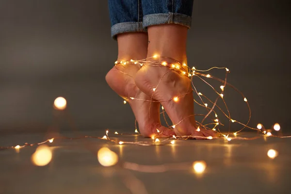 若い女の子の手順暗い背景周り明るいクリスマスの花輪が飾られています お祝いカード — ストック写真