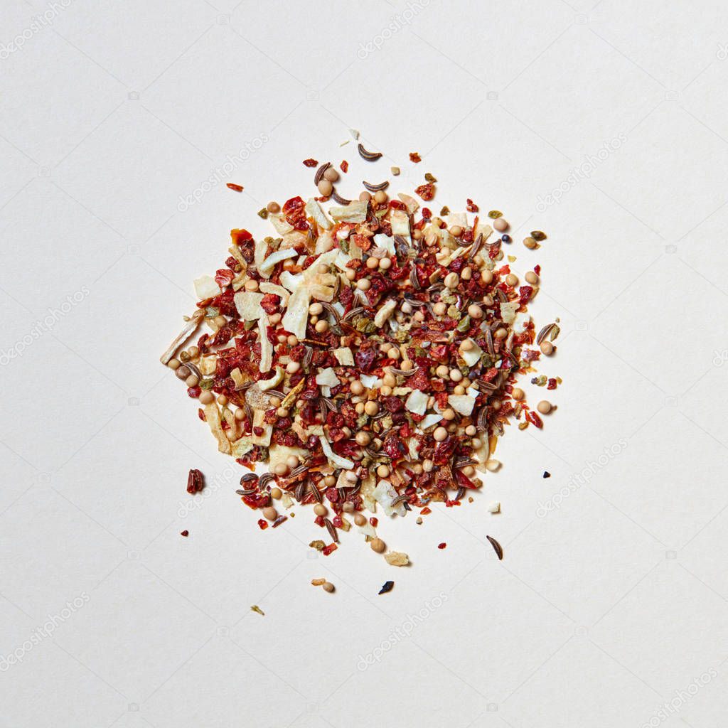 A mix of flavoring spices for the cooking of natural organic homemade food. Food and cuisine ingredients on a white with copy space. Flat lay
