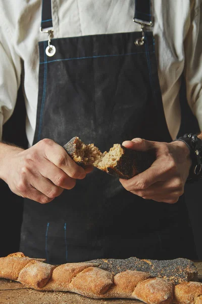 Freshly Baked Halves Baguette Hands Baker Dark Apron Background Wooden — Stock Photo, Image