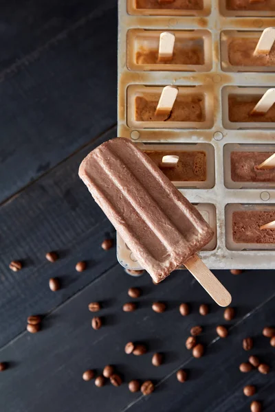 木製のテーブルの上のコーヒー豆とコーヒーのエスプレッソとミルクのアイスキャンディーをアイス キューブ コンテナーです 自家製準備コンセプト — ストック写真