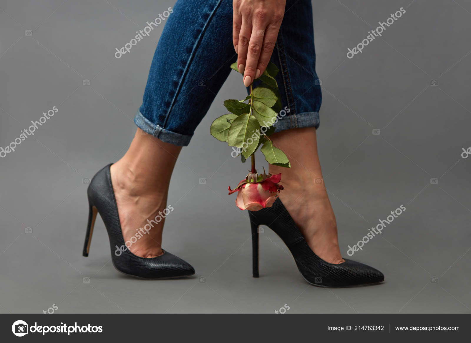 Woman In Jeans Black High Heel Shoes With A Padlock Posing On A Gray  Background Stock Photo - Download Image Now - iStock