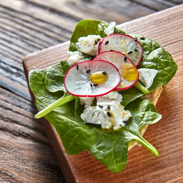 Close Ciabatta Toasts Soft Cottage Cheese Slices Radish Fresh Spinach — Stock Photo, Image