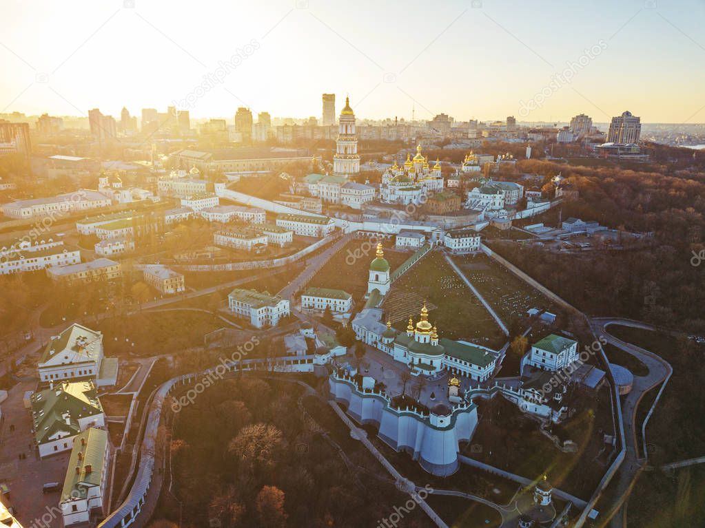 Panoramic view from the drone to the Kiev Pechersk Lavra with numerous architectural monuments at sunset in the summer. Panoramic photography from the drone.