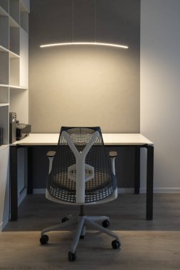 Çalışma alanında modern ofis iyi tasarlanmış ergonomi. Bilgisayar tablo, ortopedik sandalye ve resepsiyon yukarıda yumuşak aydınlatma.