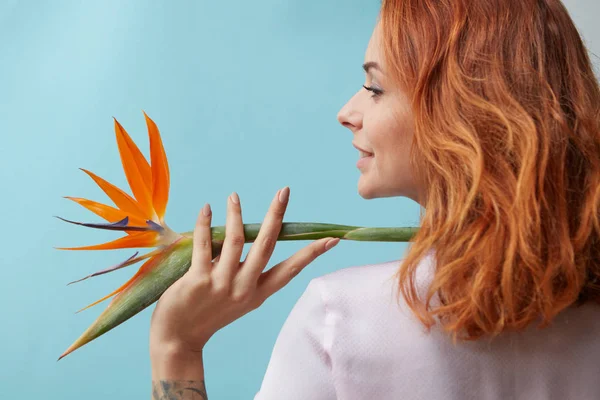 Rossa Ragazza Felice Tenendo Sulla Spalla Fiore Arancione Strelitzia Intorno — Foto Stock