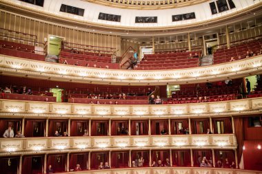View of the interior of the Vienna State Opera auditorium with the audience on balconies before starting performance in Vienna, Austria. clipart