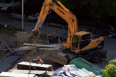 Tyumen, Rusya, 5 Haziran 2020: İnşaat. Çok katlı bir evin bahçesine su boruları döşemek..