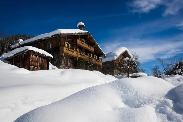 Chalets de domaine skiable en bois dans la neige — Photo