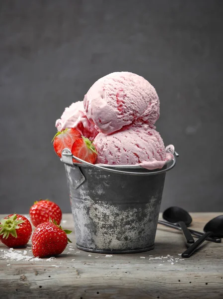 strawberry and coconut ice cream on wooden table