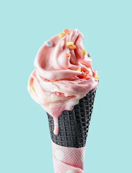 Pink melting ice cream in black waffle cone — Stock Photo, Image