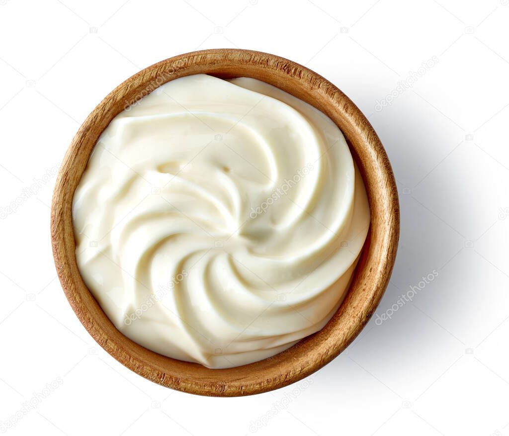 whipped cream cheese in wooden bowl isolated on white background, top view