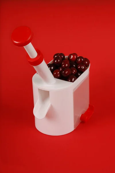 Kitchen Device Extracts Bones Cherry Berries Isolated Red Background Soft — Stock Photo, Image