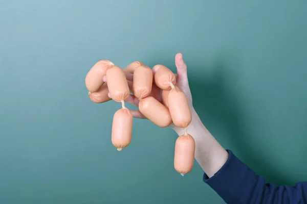 Sausages in a girl hand — Stock Photo, Image