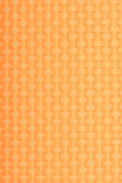 Textura de una esterilla de polietileno naranja brillo gimnasio. Textura de esterilla de yoga . — Foto de Stock